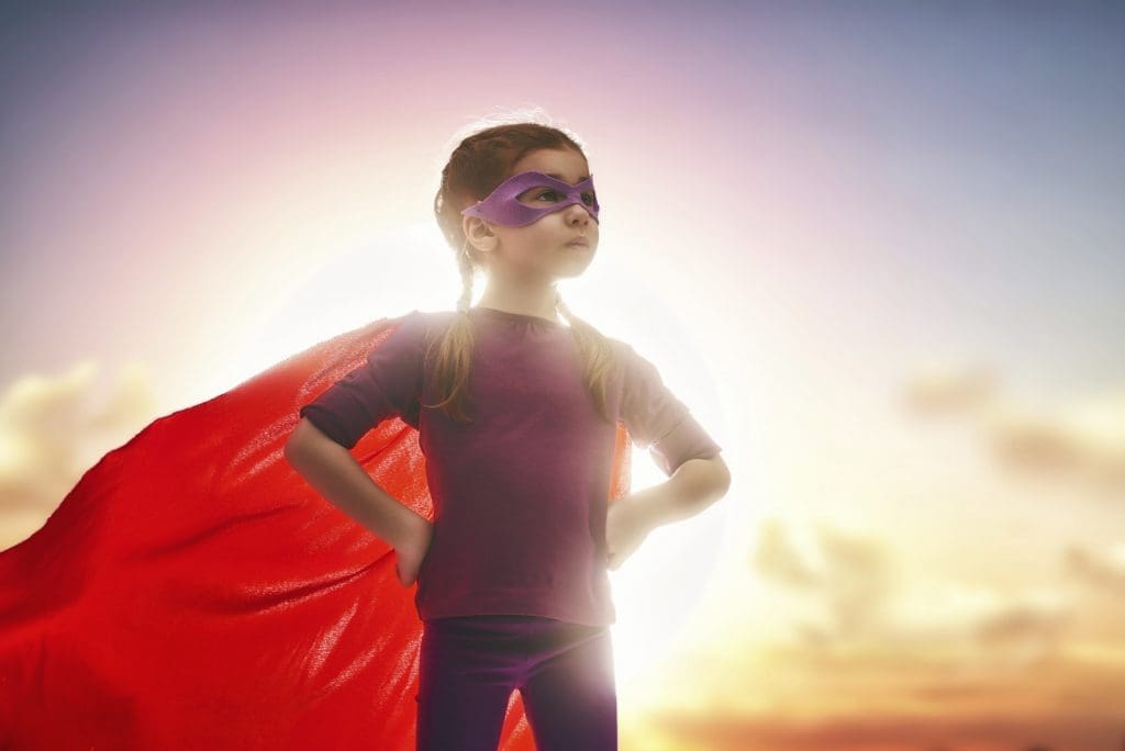small girl dressed like a superhero
