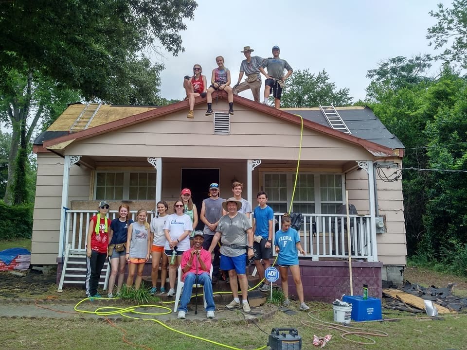 volunteers roofing a house