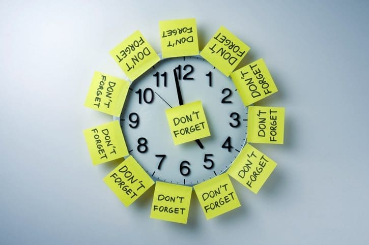 Clock with "Don't Forget" sticky notes