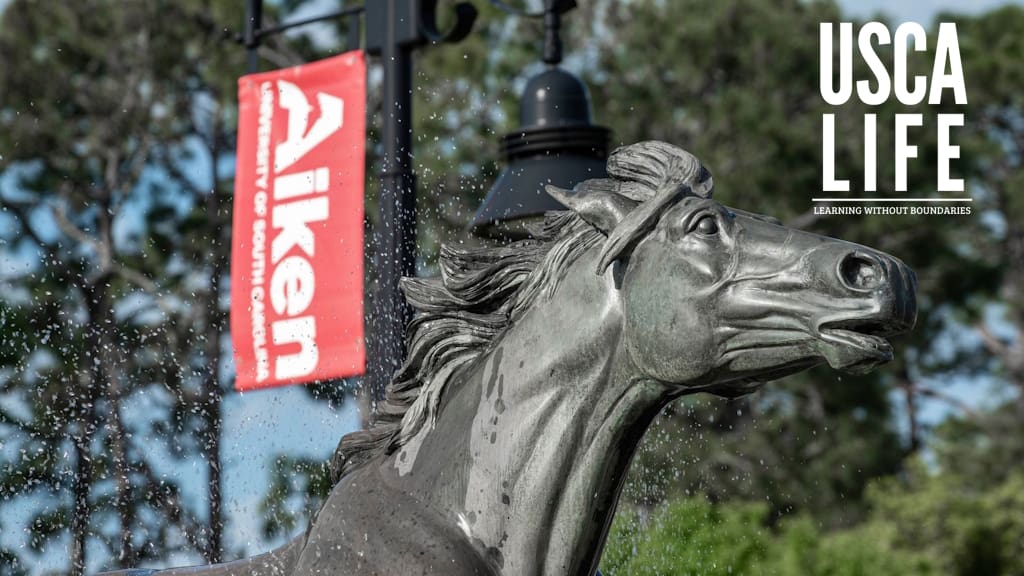 horse statue and USC Aiken with USCA LIFE logo in top right corner